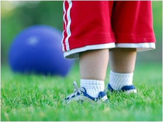 student kicking ball in physical education